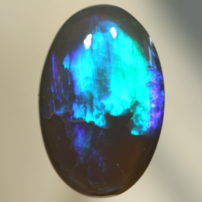 SOLID BLACK CRYSTAL OPAL Two large rolling flashes, green and turquoise shades SEE VIDEO
